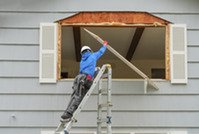 Image of contractor working on replacing the window of a house