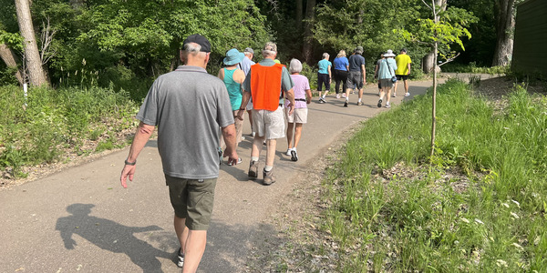 adults walking on trail outside