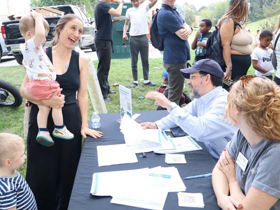 Residents laughing with city staff at a tabling event