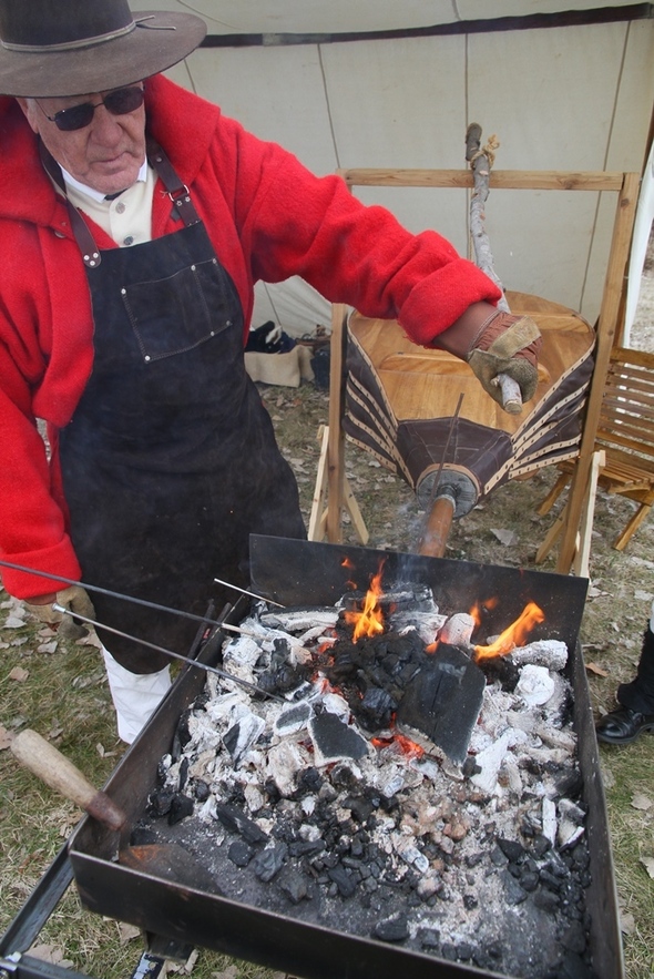 Living history reenactor demonstrating blacksmithing