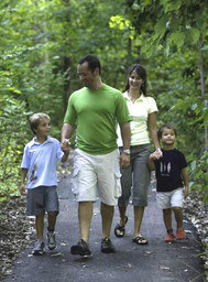 Family walking on wooded trail