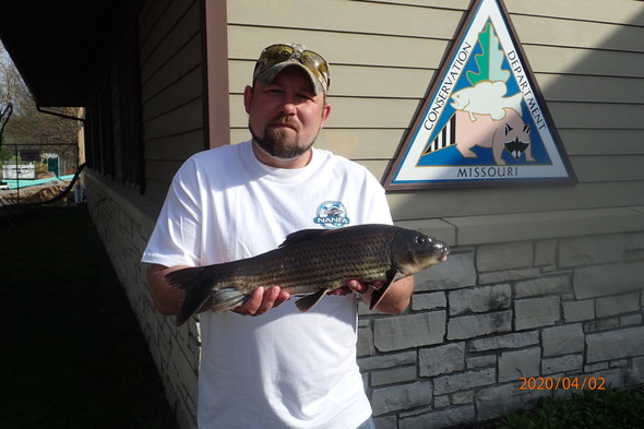 Tyler Goodale poses with his state record spotted sucker