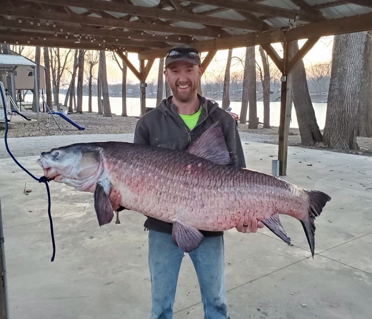 Jesse Hughes holds black carp