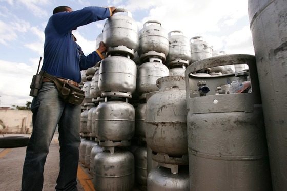 Man lifting an unlabeled container in a stack of similar containers