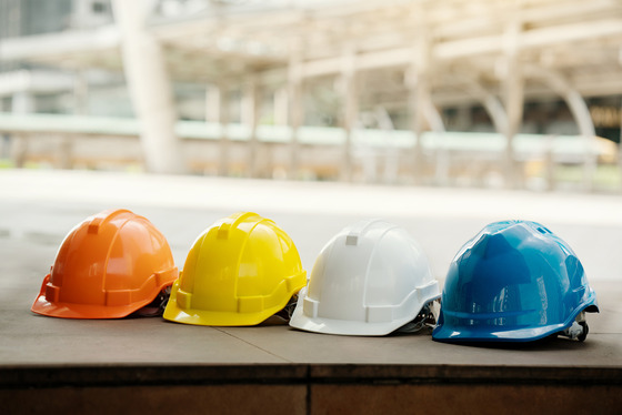 A row of safety helmets of different colors