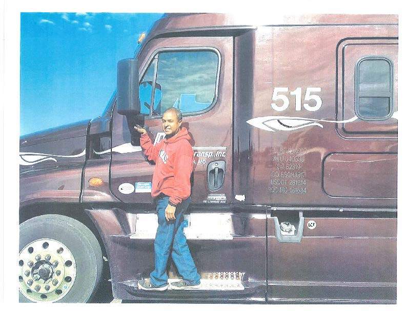 Terence Gahie standing by his truck