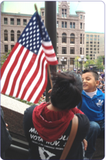 March Photo Woman and Child with Flag by City Hall
