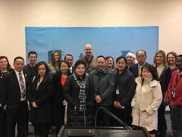 Hmong Elders Pose with Minneapolis City Staff at Joint Information Center during 2018 Superbowl