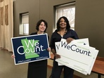 Michelle Rivero and Alberder Gillespie holding We Count signs at 2020 Census kickoff celebration