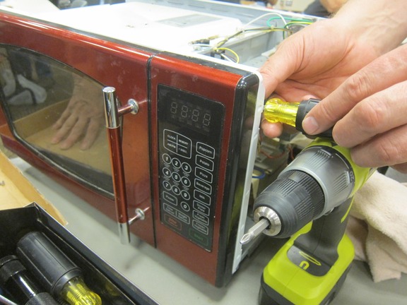 Microwave being repaired at a Hennepin County Fix It Clinic