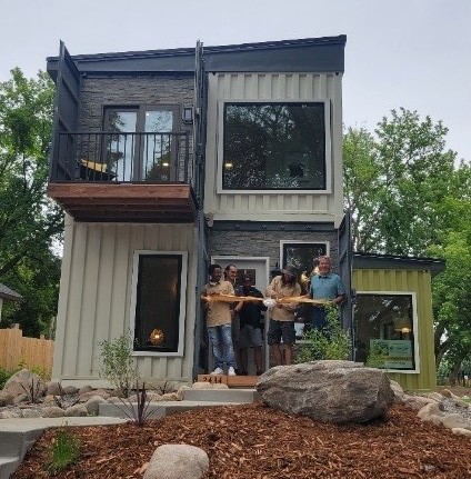 people outside of a container home in Minneapolis