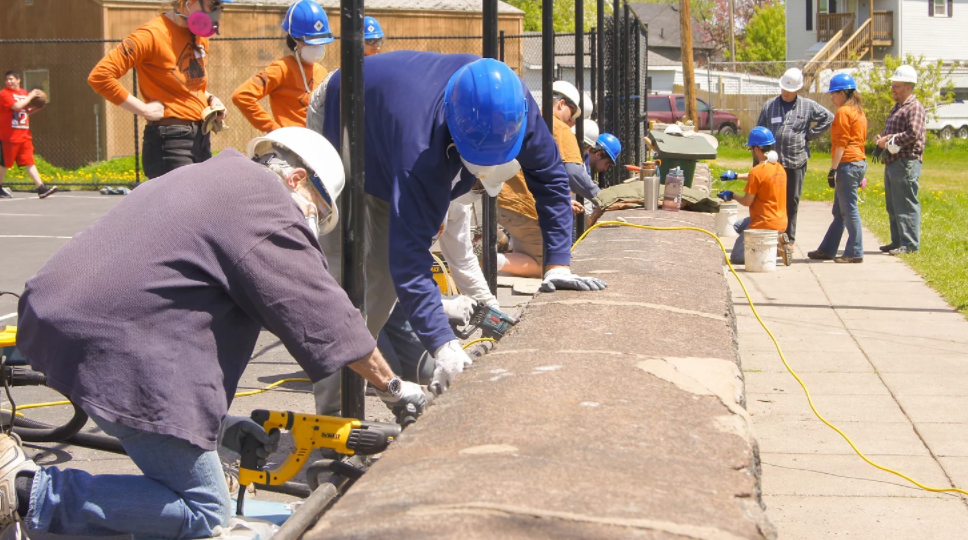 Construction workers weatherizing a building