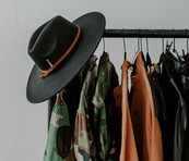 shirts and hats on hangers in store