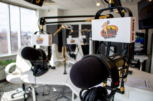 La Raza set of Mi Ciudad Minneapolis radio show studio photo of microphones and logo