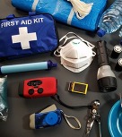 Photo of items in an emergency prep kit, including first aid kit, face masks, flashlight, etc. 