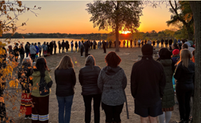 Sunrise ceremony at Bde Maka Ska crowd in a circle