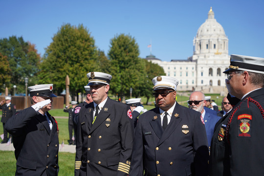 Mpls Fire Dept Chief Tyner (right) and St. Paul Fire Dept Chief Inks walk through the processional at the MN Fallen Firefighter Memorial Service.