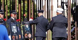 Mpls Fire Dept Chief Bryan Tyner presented the rose in honor of Mpls Fire Capt. LeRoy Swenson, who lost his life in 1997.