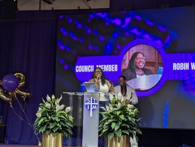 Council Member Wonsley speaking alongside Bishop Richard Howell 