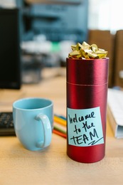 water bottle with a welcome to the office note attached