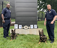 Head Trainer Officer Joe Fuller, K9 Rock, Sgt. Brian Thureson, and K9 Riggs with their awards from the regional competition