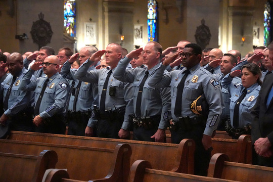 Minneapolis Police Department officers salute Minnesota's fallen first responders at the Blue Mass on Oct. 30 at the Basilica of Saint Mary.