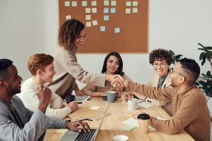 People shaking hands at meeting