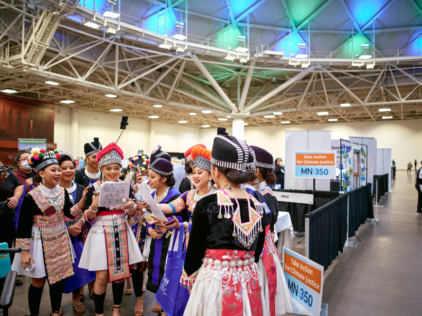 Hmong dancers explore exhibit hall at 2023 Community Connections Conference