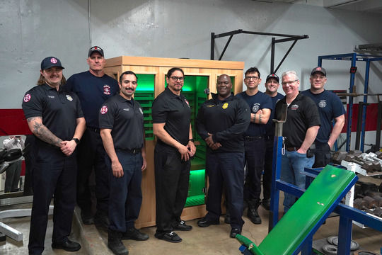 Members of Minneapolis Fire Department Station 7 stand in front of the new infrared sauna