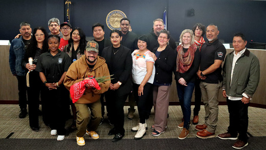 Council Member Jason Chavez and Council Vice President Aisha Chughtai pose with leaders of the immigrant rights and labor movement