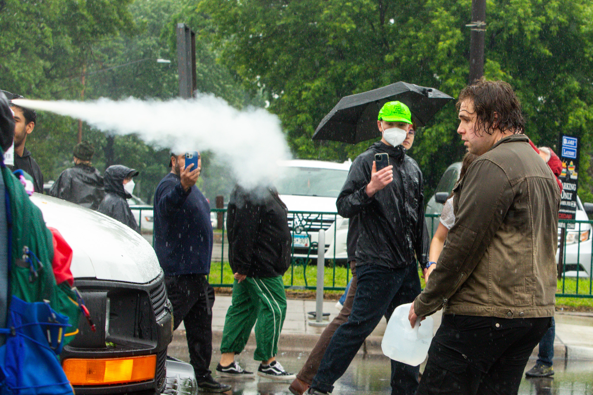 null An officer sprays mace at protestors while a legal observer films. Credit: Minnesota Reformer.
