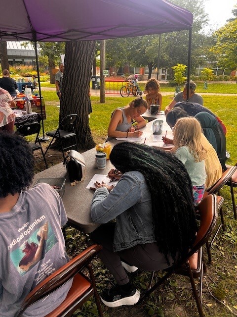 Council Member Wonsley enjoying the craft table with neighbors of all ages at the Luxton Park National Night Out Mobile Jazz event.