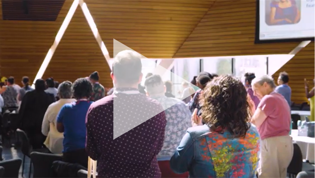 Trans Equity Summit standing ovation with video play button overlay