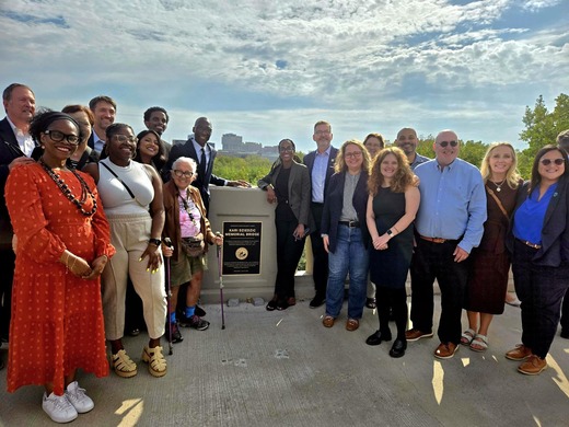 Council Member Wonsley stands with city, county, and state elected leaders at the Senate Majority Leader Kari Dziedzic Memorial Bridge. 