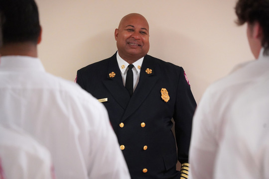 Fire Chief Tyner beams at a new class of firefighters who celebrated their graduation from the training academy.