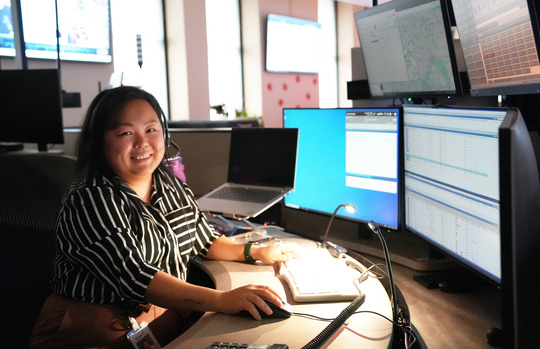 Melanie Yang, the new 911 embedded social worker, sits at her work station in the MECC.