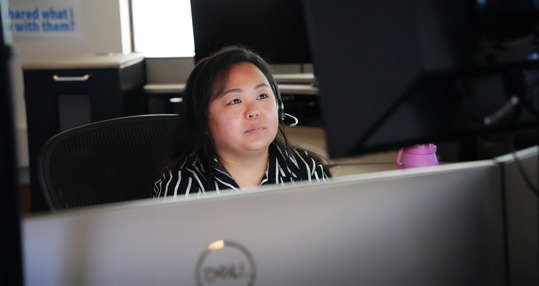 Melanie Yang in her workspace at the Minneapolis Emergency Communications Center.