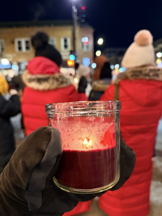 Candle being held at Alex Pretti memorial site