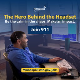 911 telecommunicator working at desk