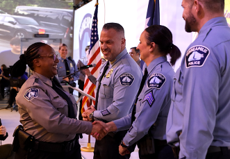 Chief O'Hara shakes hands with an MPD CSO.