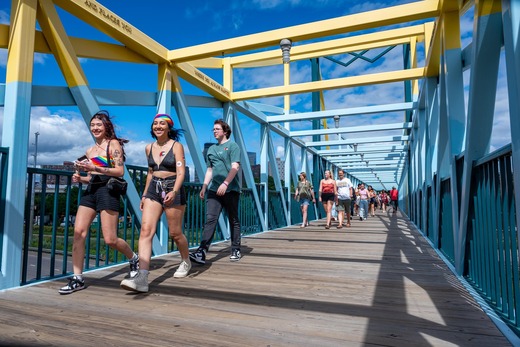 Pride attendees crossing the Armajani bridge to the Sculpture Garden