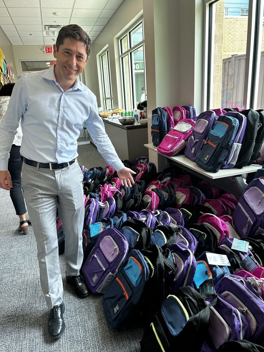 Mayor Frey with backpacks for Minneapolis children and families ahead of another school year.