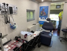 An interior photo of the City of Minneapolis Mobile Medical Unit with an exam chair and medical supplies.