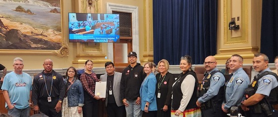 Council Member Jason Chavez poses with guests in City Council Chambers holding an honorary resolution honoring Indigenous Peoples Day 