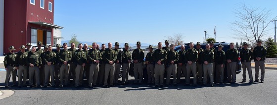 MHP graduates alongside Colonel Kurt Sager and Lieutenant Colonel Kyle Hayter (center)