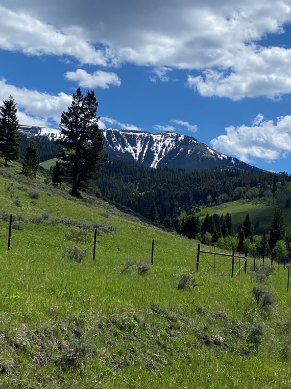 Mountains with snow, blue sky, clouds, located in Paradise Valley, Montana