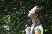 Woman breathing easy in flowers