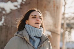 Woman breathing in cold air