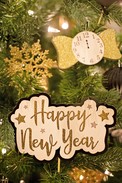Tree branches with sign that says happy new year