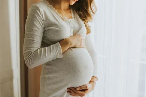 Image of woman from shoulders down who is pregnancy
